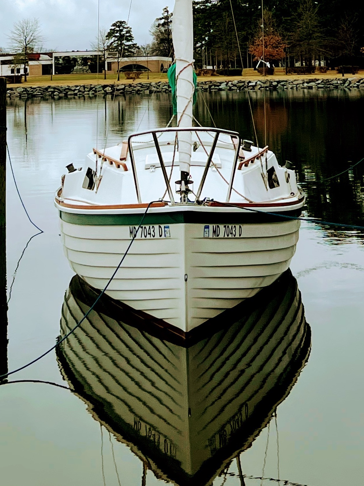 Bow-on view of Spoonful's lapstrake hull mirrored in calm water