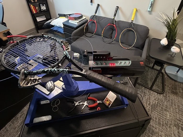 Racquet mounted on a stringing machine in the Birdman Strings workshop in Odessa, FL