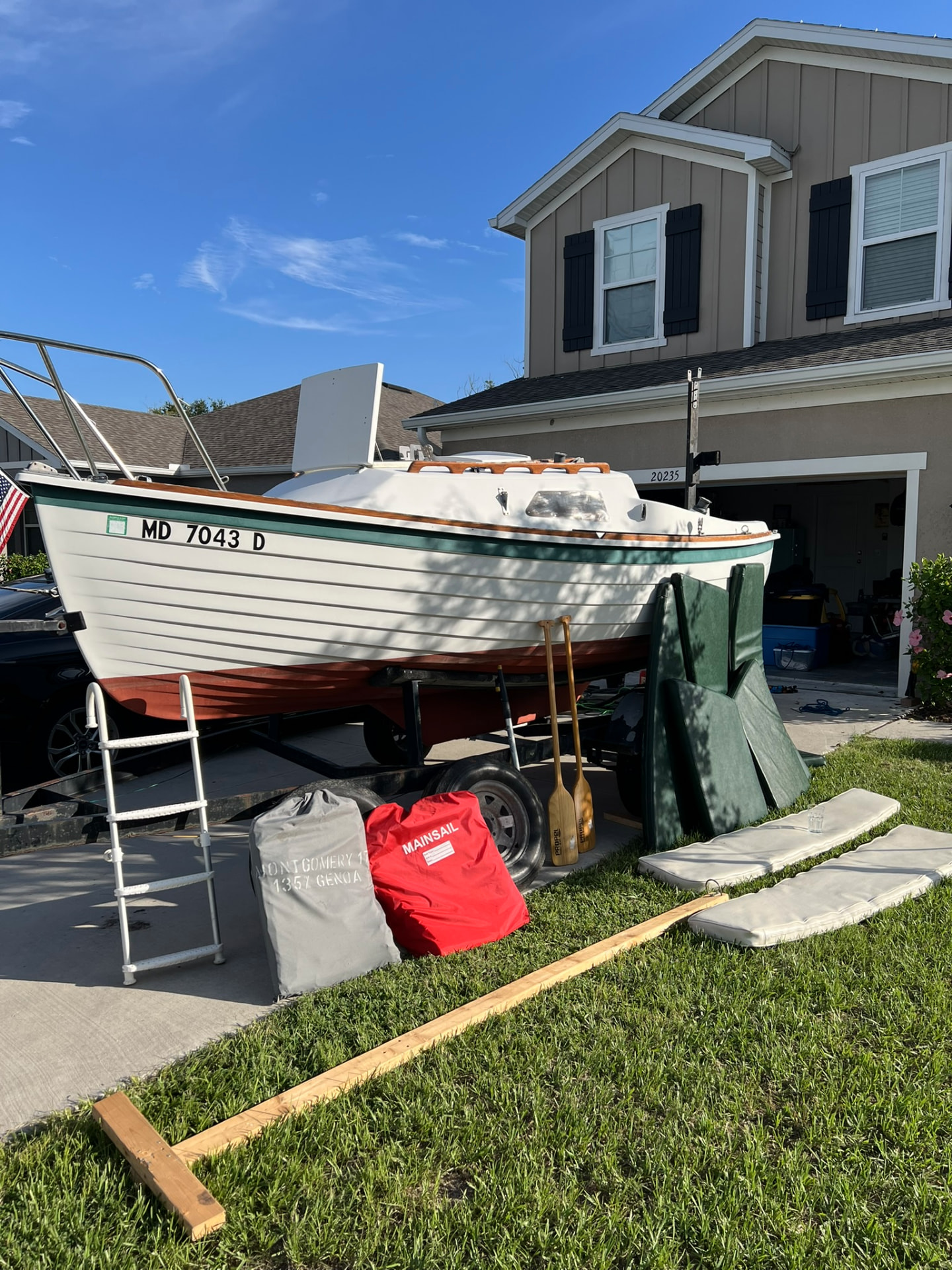 Spoonful on her trailer with boarding ladder, sails, oars and cushions alongside