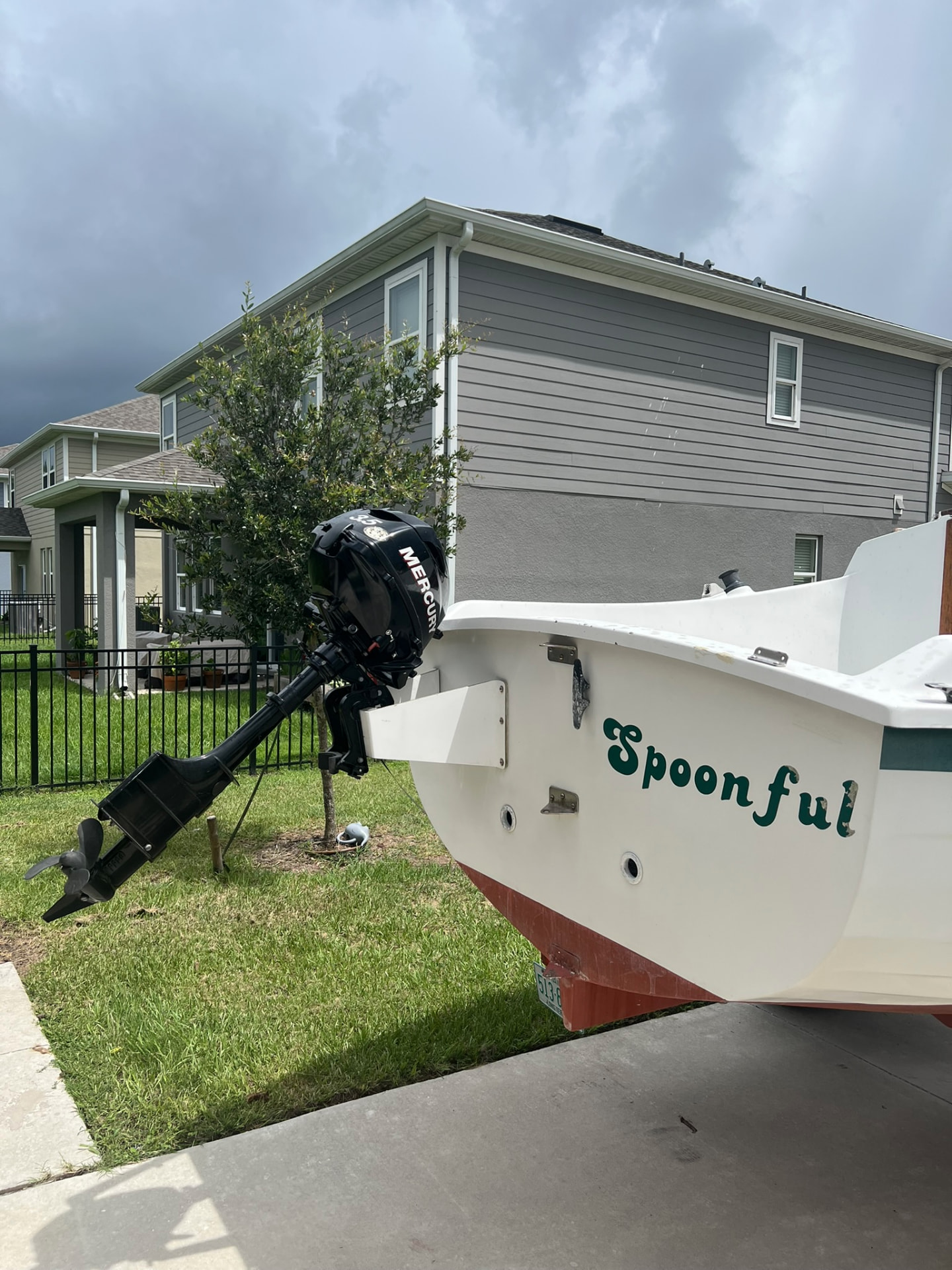 Mercury 3.5 hp outboard mounted on the transom beside Spoonful's name