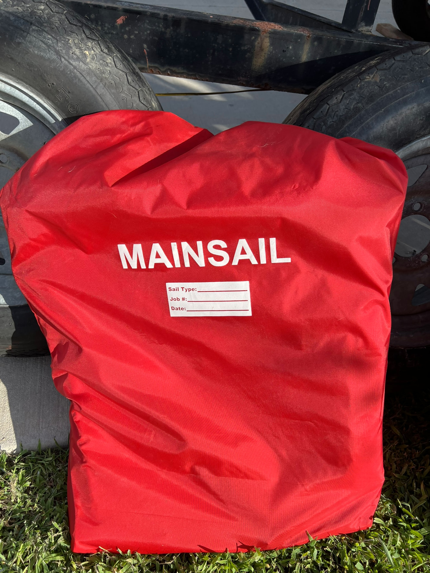 Mainsail in its red sail bag