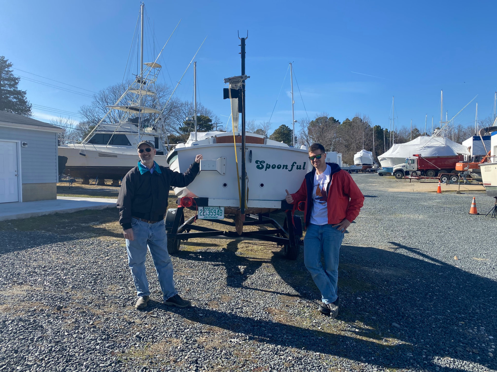 Previous owner Dick and the current owner standing beside Spoonful's transom